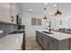 Modern kitchen featuring stainless steel appliances, stylish backsplash, and a large island with quartz countertop at 180 N Edge Cliff St, Castle Rock, CO 80104