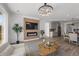 Open-concept living space with modern fireplace, chandelier lighting and view of the open kitchen at 180 N Edge Cliff St, Castle Rock, CO 80104