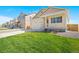 A well-maintained home on a tree-lined street features a covered porch and freshly cut green lawn at 817 Ledge St, Lochbuie, CO 80603
