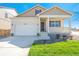 Beautiful beige single-Gathering home offers a two-car garage and a welcoming covered front porch at 817 Ledge St, Lochbuie, CO 80603