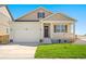 Inviting single-Gathering home boasts a two-car garage, covered porch, and manicured lawn at 817 Ledge St, Lochbuie, CO 80603