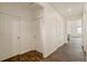 Bright and spacious hallway with hardwood flooring and multiple doorways leading to different rooms at 817 Ledge St, Lochbuie, CO 80603