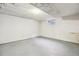 Clean, unfinished basement with concrete floors, white walls, and a small window at 5481 E Tennessee Ave, Denver, CO 80246
