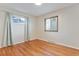 A cozy bedroom features hardwood floors, neutral walls, and natural light from two windows at 5481 E Tennessee Ave, Denver, CO 80246