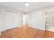 Spacious bedroom featuring hardwood floors, a closet, and an en-suite bathroom with a shower at 5481 E Tennessee Ave, Denver, CO 80246
