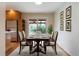 Bright dining room features a wood table set with seating for six, decorative wall art, and a sliding glass door to the yard at 5481 E Tennessee Ave, Denver, CO 80246
