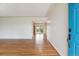 Inviting entryway with hardwood floors leads to an open floor plan and a striking turquoise front door at 5481 E Tennessee Ave, Denver, CO 80246