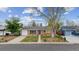 Charming single-story home with brick facade, lush lawn, mature trees, and a vibrant turquoise front door at 5481 E Tennessee Ave, Denver, CO 80246