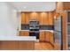 Updated kitchen with stainless steel appliances, patterned backsplash and stone countertops at 5481 E Tennessee Ave, Denver, CO 80246