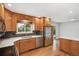 Updated kitchen features stainless steel appliances and opens to dining area at 5481 E Tennessee Ave, Denver, CO 80246