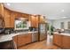 Updated kitchen features stainless steel appliances and opens to dining area at 5481 E Tennessee Ave, Denver, CO 80246
