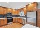 Updated kitchen features stainless steel appliances, stone countertops and patterned backsplash at 5481 E Tennessee Ave, Denver, CO 80246