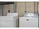 A laundry area featuring a white washer and dryer with easy-to-use controls at 5481 E Tennessee Ave, Denver, CO 80246