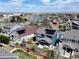 Aerial view of a neighborhood with homes, landscaping, and a scenic lake nearby at 10733 Salida St, Commerce City, CO 80022