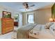 Cozy bedroom with a wooden dresser and a view of the adjacent bathroom, creating a serene retreat at 10733 Salida St, Commerce City, CO 80022