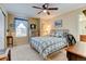 Cozy bedroom featuring a ceiling fan, a large window, and comfortable furnishings at 10733 Salida St, Commerce City, CO 80022