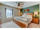 Comfortable bedroom with a large window, ceiling fan, and tranquil green accent wall enhancing its appeal at 10733 Salida St, Commerce City, CO 80022