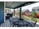 Relaxing deck with shaded table and chairs, overlooking the landscaped backyard at 10733 Salida St, Commerce City, CO 80022