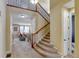Inviting foyer with carpeted stairs and a view into the living room at 10733 Salida St, Commerce City, CO 80022