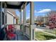 Covered front porch with white columns and red chairs at 10733 Salida St, Commerce City, CO 80022