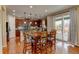Eat-in kitchen with hardwood floors, dark wood cabinetry, granite countertops, and access to the back deck at 10733 Salida St, Commerce City, CO 80022