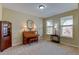 Cozy living room with neutral walls and carpet, featuring a piano and a dark wood cabinet at 10733 Salida St, Commerce City, CO 80022
