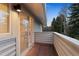 Cozy outdoor balcony with brick flooring and views of surrounding trees and sky at 2552 E Alameda Ave # 32, Denver, CO 80209