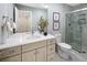 Elegant bathroom with marble tile, a glass-enclosed shower, and a vanity with modern fixtures at 2552 E Alameda Ave # 32, Denver, CO 80209
