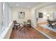 Bright dining area with a glass table, brick floors, and ample natural light from large windows at 2552 E Alameda Ave # 32, Denver, CO 80209