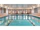 Beautiful indoor pool area with ample windows and lounge chairs at 2552 E Alameda Ave # 32, Denver, CO 80209