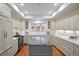 Spacious kitchen featuring white cabinetry, a center island, and modern stainless-steel appliances at 2552 E Alameda Ave # 32, Denver, CO 80209