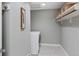 A well-organized laundry room features modern appliances, a storage shelf, and elegant tile flooring for added convenience at 2552 E Alameda Ave # 32, Denver, CO 80209