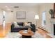Bright living room featuring hardwood floors, a fireplace, and modern decor at 2552 E Alameda Ave # 32, Denver, CO 80209