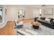 Spacious living room with hardwood floors, office access and neutral decor at 2552 E Alameda Ave # 32, Denver, CO 80209