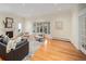 Spacious living room with a fireplace, hardwood floors, and large windows, perfect for entertaining and relaxation at 2552 E Alameda Ave # 32, Denver, CO 80209