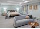 Tranquil bedroom with tray ceilings, a cozy sitting area, and ample natural light at 2552 E Alameda Ave # 32, Denver, CO 80209