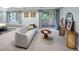 Bright bedroom with a comfortable seating area, sliding glass doors and natural light at 2552 E Alameda Ave # 32, Denver, CO 80209
