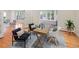 Charming home office features a wooden desk, stylish chairs, and sunlit windows at 2552 E Alameda Ave # 32, Denver, CO 80209