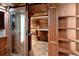 Wine cellar with wood details, decorative glass door, shelving, and space for wine storage at 2552 E Alameda Ave # 32, Denver, CO 80209