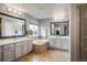 Bright bathroom with double vanity, soaking tub, tile floors, and spa-like atmosphere at 1870 Alpine Dr, Erie, CO 80516