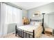 Bedroom with a black metal bed frame, carpet, and a window with curtains at 1870 Alpine Dr, Erie, CO 80516