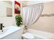 Updated bathroom with vanity, tile accents, and shower/tub combo at 8627 Santa Fe Dr, Thornton, CO 80260