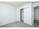 An empty bedroom features neutral walls, carpeted floor, and a closet at 8627 Santa Fe Dr, Thornton, CO 80260