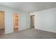 Spacious bedroom features new paint, carpet, and a view of the en-suite bathroom at 8627 Santa Fe Dr, Thornton, CO 80260