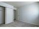 An empty bedroom features neutral walls, carpeted floor, and a closet at 8627 Santa Fe Dr, Thornton, CO 80260