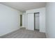 Bright bedroom featuring plush gray carpet, neutral paint, and a spacious closet at 8627 Santa Fe Dr, Thornton, CO 80260