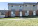 Exterior elevation of townhome featuring a well-manicured lawn at 8627 Santa Fe Dr, Thornton, CO 80260