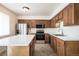 Well-lit kitchen featuring stainless appliances, sleek countertops, and a functional island at 8627 Santa Fe Dr, Thornton, CO 80260