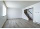 Bright living room with modern gray flooring and staircase access to upper level at 8627 Santa Fe Dr, Thornton, CO 80260