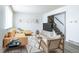 Bright living room with sleek gray flooring, a comfortable couch, and a staircase to the upper level at 8627 Santa Fe Dr, Thornton, CO 80260
